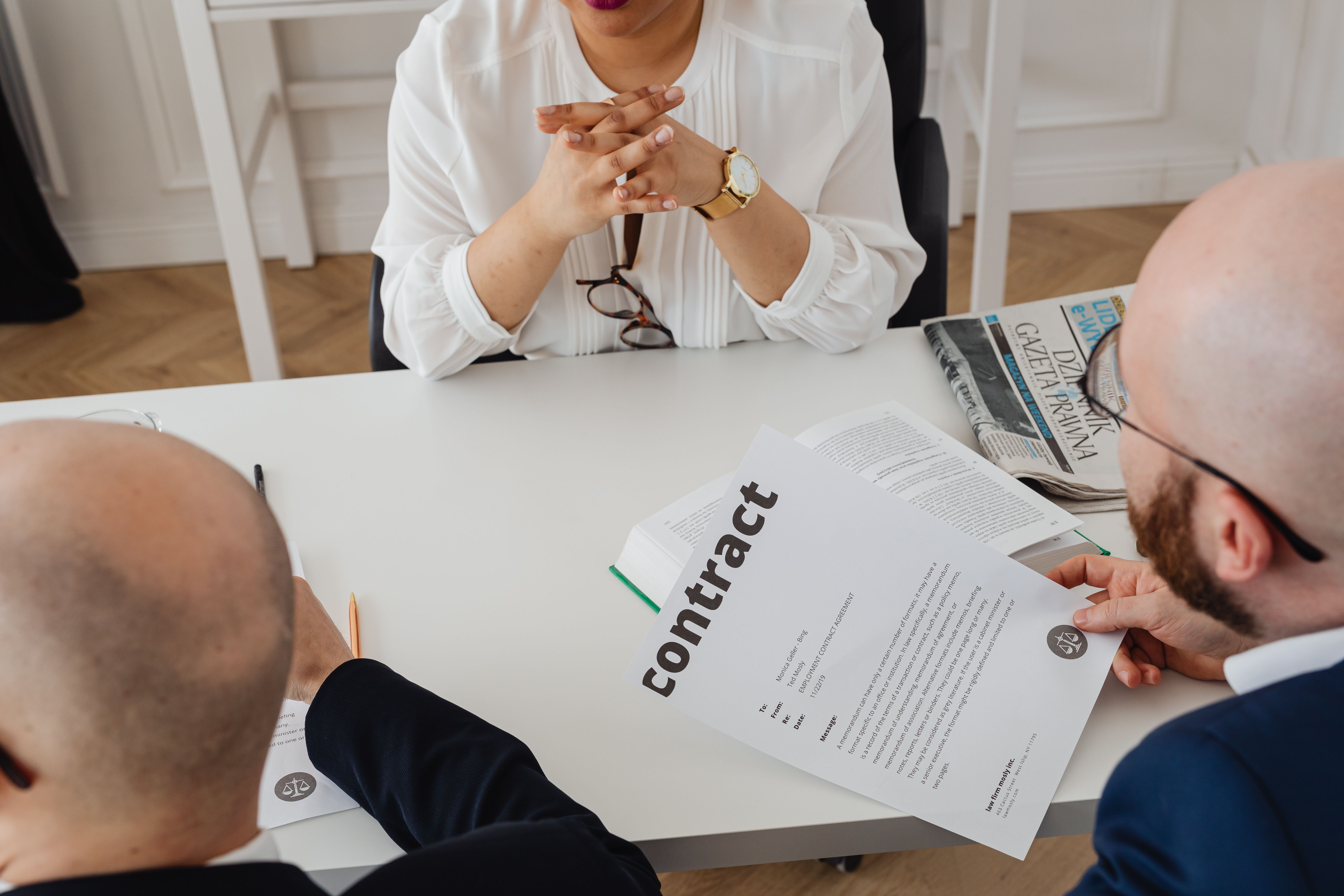 Business professionals discussing a contract in a modern office