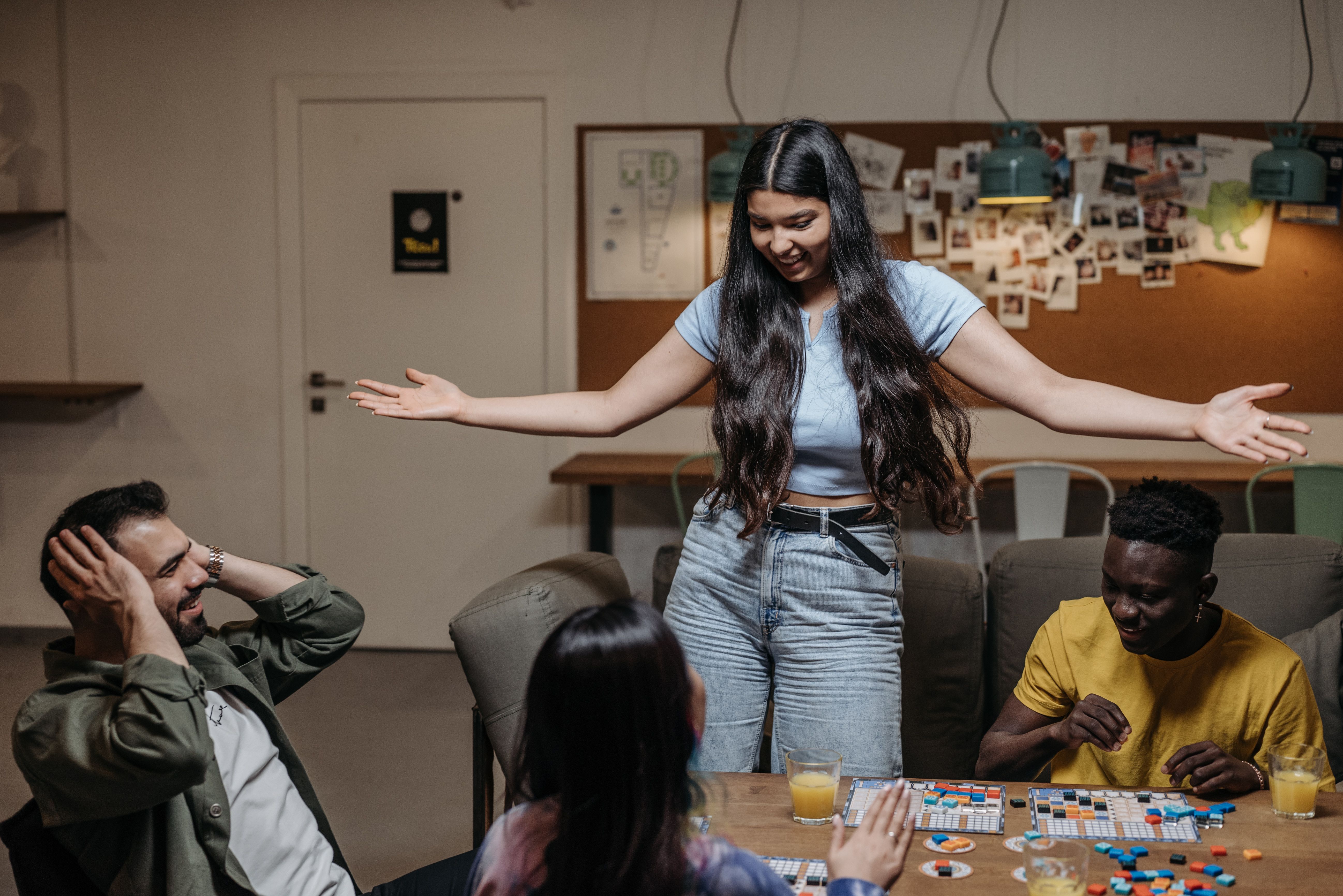 A diverse group of friends playing board games together, representing a low-pressure way to meet people offline.